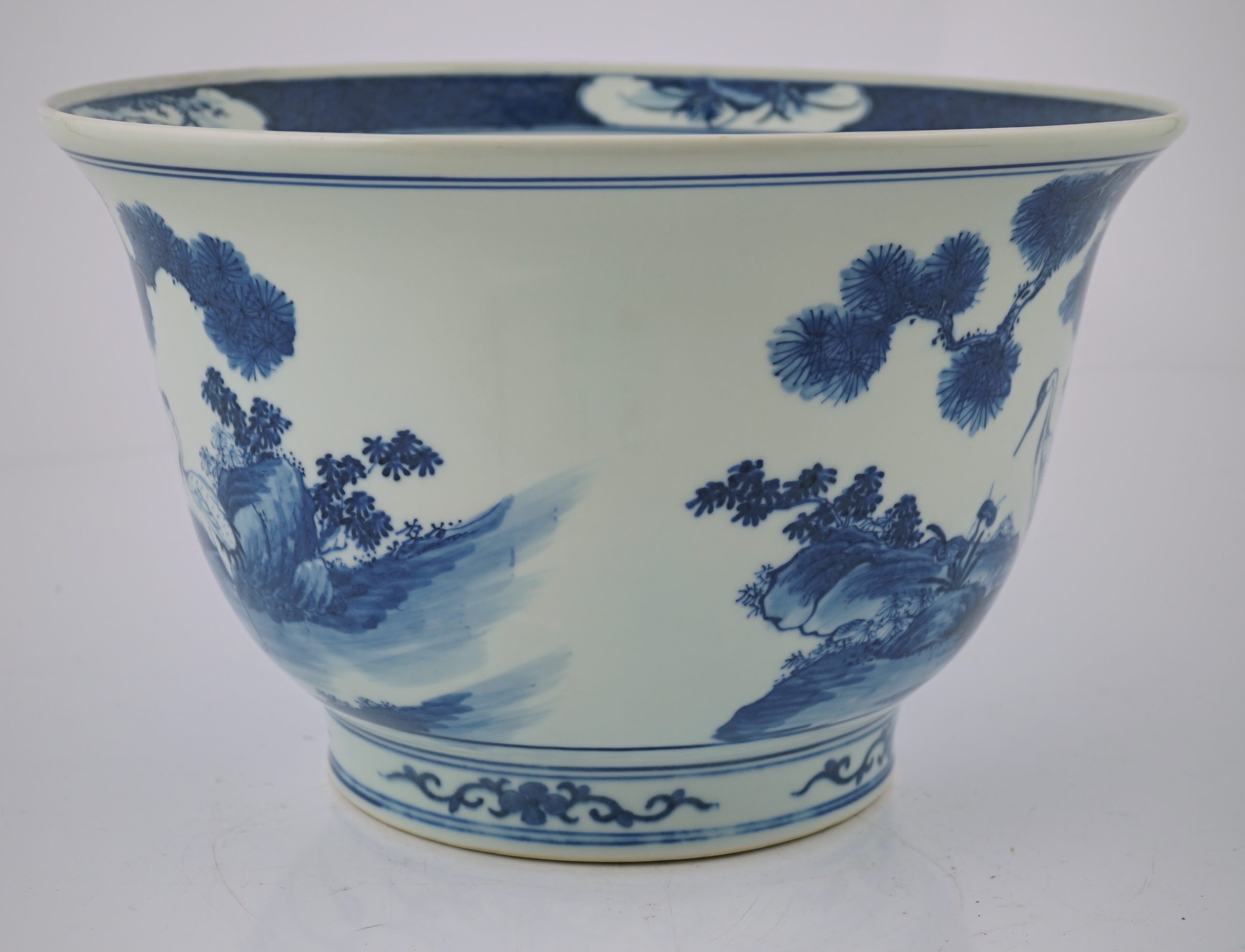 A Chinese blue and white 'deer and cranes' planter, 19th century, restoration to rim and a crack to the base